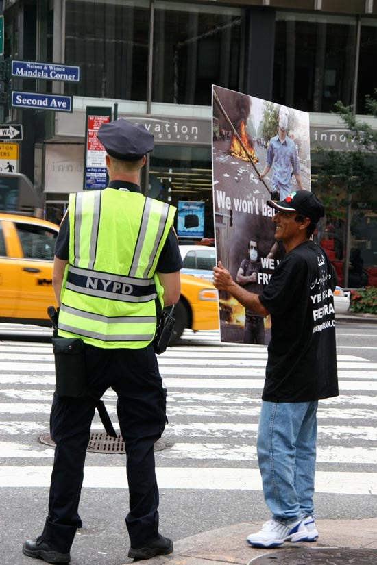 Protester and police officer on street