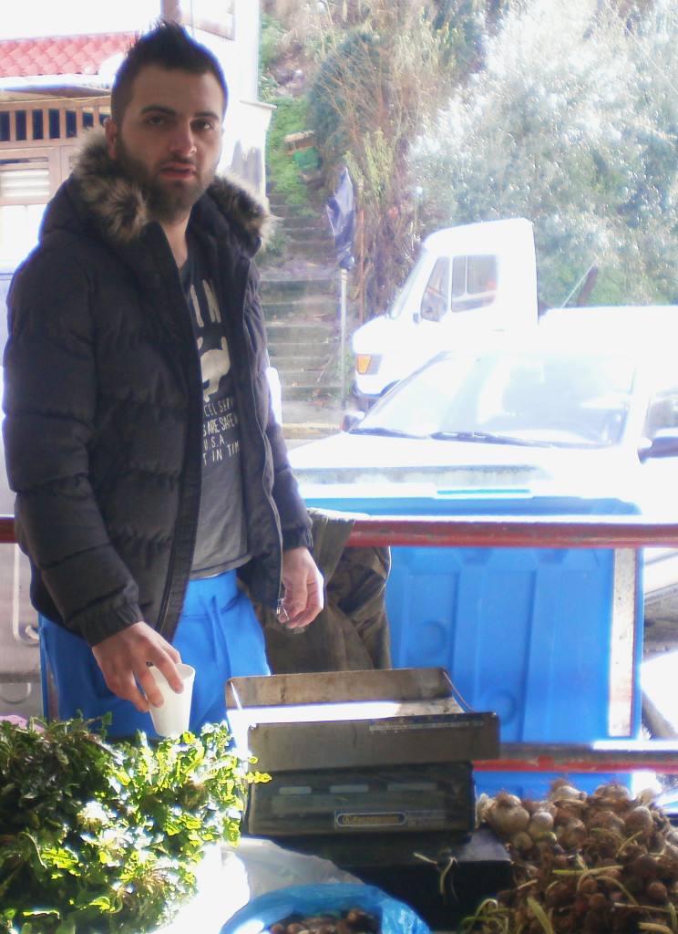 Vassilis Psonis poses at his stall in the farmers' market