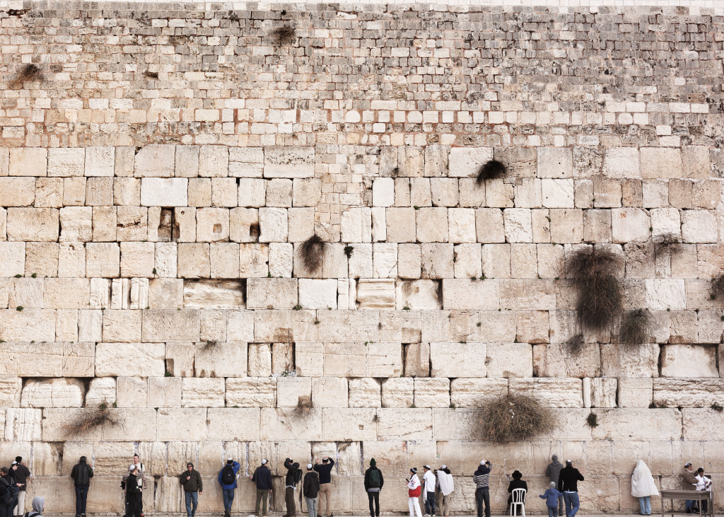 Men standing in front of the Wailing Wall