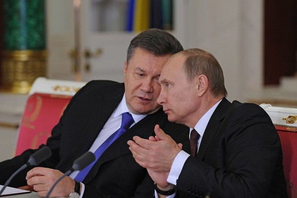 Ukrainian president Viktor Yanukovich and Russian president Vladimir Putin seated and talking in Kremlin