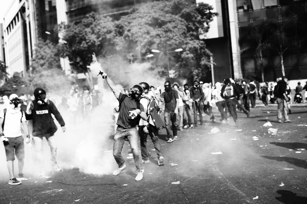 Protesters wearing gas masks on the streets of Caracas