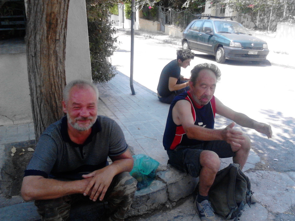 Homeless Polish immigrants sitting on curb