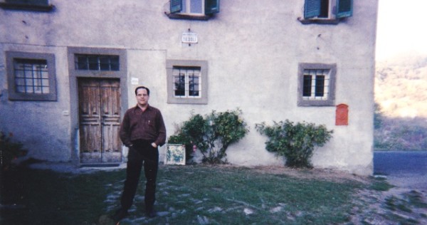Author in front of house door and sign