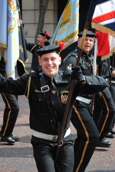 Man with flag dances and smiles