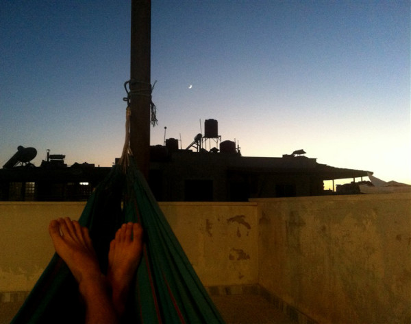 Person in a hammock on a rooftop
