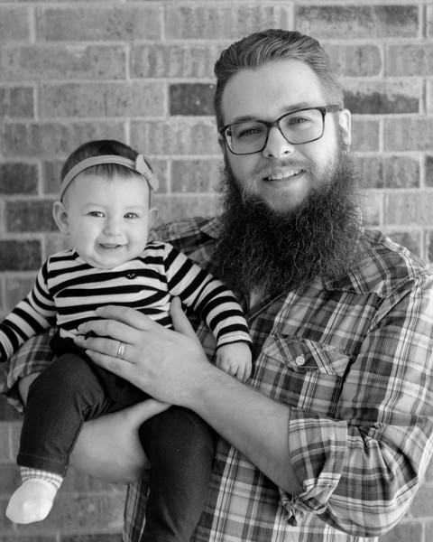 Black-and-white portrait of stay-at-home dad and his baby daughter