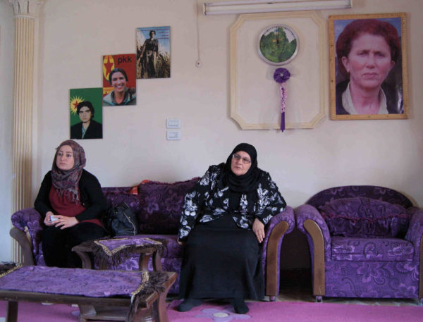 Two women sitting in the women's house in Rojava