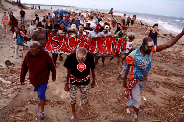 Protesters walking on beach