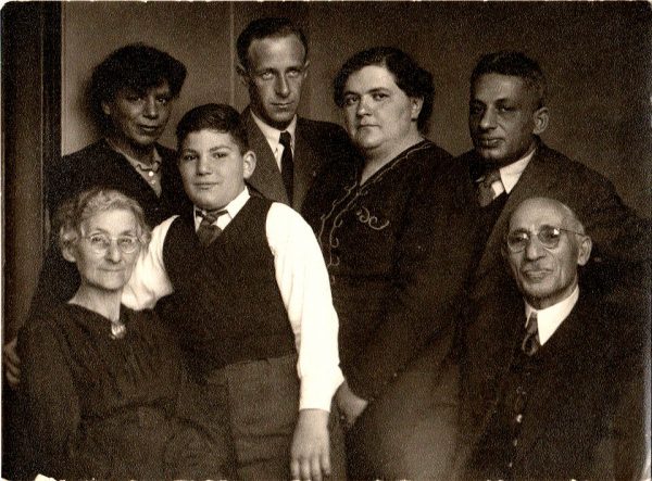 Black-and-white photo of seven family members posing for family portrait
