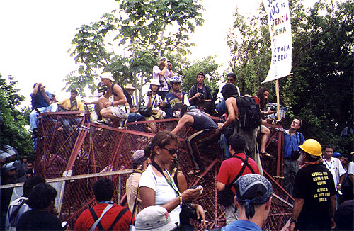 People sitting on top of crumpled fence