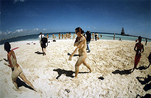 Naked protesters walking down the beach