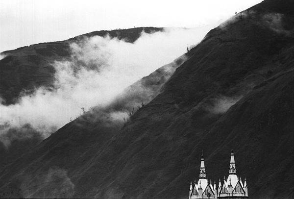Clouds along the mountains with the tops of the church visible