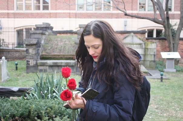 Cynthia Pelayo writes a note to Edgar Allan Poe before leaving her own tribute at his grave.
