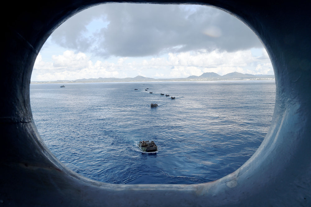 Amphibious assault vehicles in ocean, seen from well deck