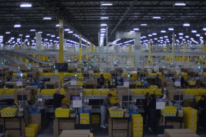 Wide-angle shot of workers on the floor of an Amazon warehouse