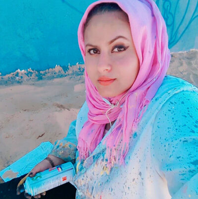 Photo of Mariam Salah hearing a pink headscarf and blue shirt